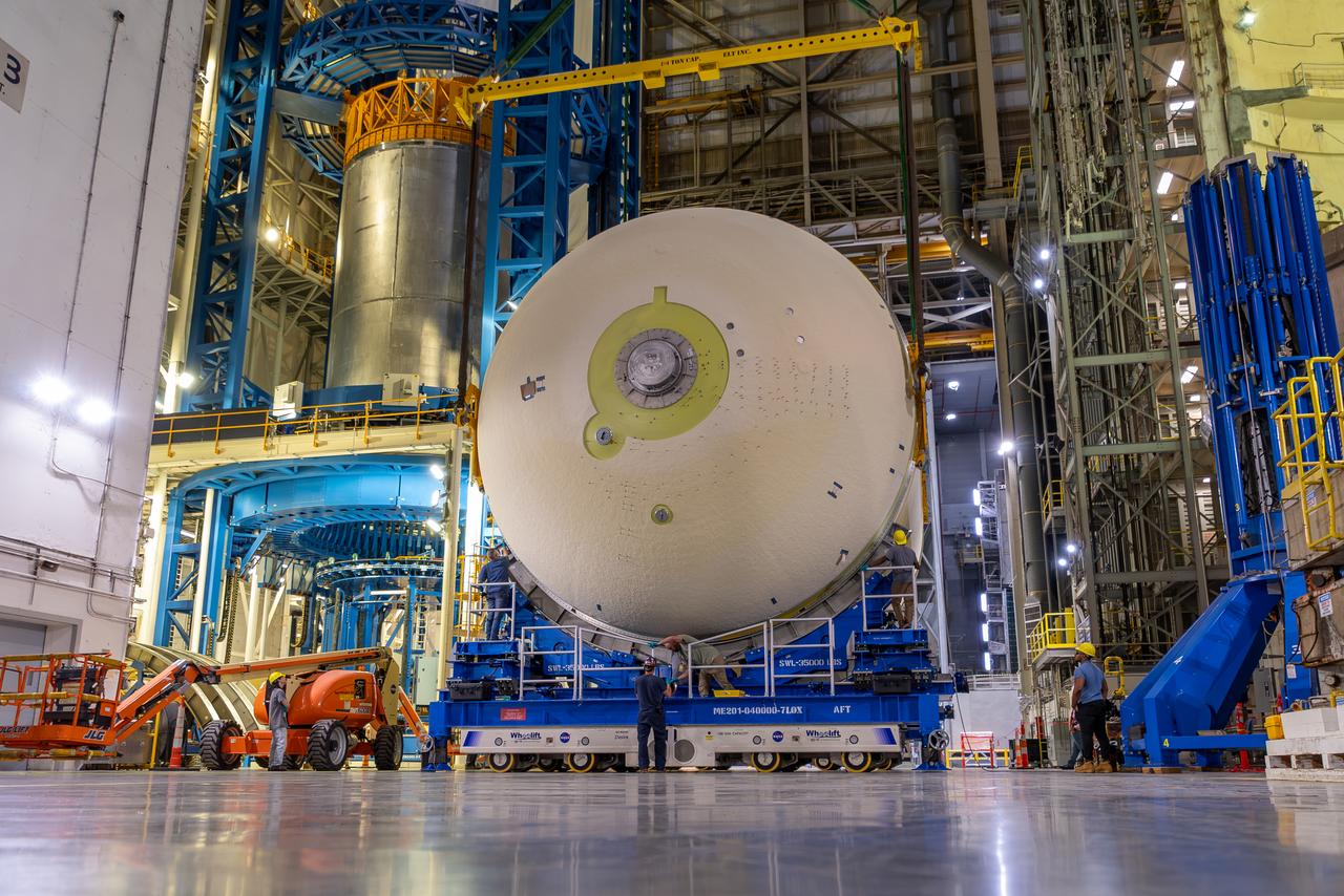 Move crews at NASA’s Michoud Assembly Facility in New Orleans perform “breakover” operations on a liquid oxygen tank in the facility’s vertical assembly building on Aug. 22, 2025. During the breakover, teams lifted the tank from its vertical configuration inside of a production cell and set it horizontally atop self-propelled mobile transporters for transfer to the final assembly production area. There, it will undergo integration of the forward dome by SLS (Space Launch System) prime contractor, Boeing. Eventually, the liquid oxygen tank will be moved back to the high bay where it will be mated with the intertank and forward skirt to complete the forward join of the Artemis III core stage. The propellant tank is one of five major elements that make up the 212-foot-tall rocket stage. The core stage, along with its four RS-25 engines, produce more than two million pounds of thrust to help launch NASA’s Orion spacecraft, astronauts, and supplies beyond Earth’s orbit and to the lunar surface for Artemis.
